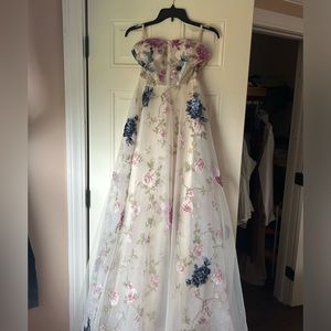 Bridal gown with corset top & mesh overhang. Hand embroidered flowers